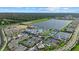 Expansive aerial view of the community with tennis courts and lakeside homes at 26000 Seastone Dr, Englewood, FL 34223