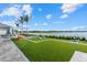 Expansive outdoor space with artificial turf, lawn games, and scenic water views for ultimate enjoyment at 26000 Seastone Dr, Englewood, FL 34223