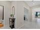 Inviting hallway featuring neutral colors, tiled floors and a decorative table at 26000 Seastone Dr, Englewood, FL 34223