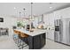Bright, modern kitchen with a large island, stainless steel appliances, and a seating area at 26000 Seastone Dr, Englewood, FL 34223
