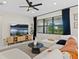 Comfortable living room features a cozy chaise lounge, modern decor, and a large window for natural light at 26000 Seastone Dr, Englewood, FL 34223