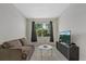 Cozy living room with comfortable sofa, marble table, and streaming television at 26000 Seastone Dr, Englewood, FL 34223