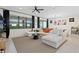 Inviting living room with large windows, modern sofa, and stylish decor at 26000 Seastone Dr, Englewood, FL 34223