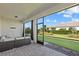 Covered patio featuring paved flooring, outdoor seating, and views of the manicured lawn at 26000 Seastone Dr, Englewood, FL 34223