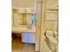 Bathroom with a large vanity and toilet, decorated with wallpaper at 2675 Gulf Of Mexico Dr # 203, Longboat Key, FL 34228