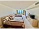 Bright bedroom with two beds, dresser and ocean view at 2675 Gulf Of Mexico Dr # 203, Longboat Key, FL 34228