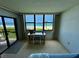 Bedroom with balcony access, water view, and desk at 2675 Gulf Of Mexico Dr # 203, Longboat Key, FL 34228