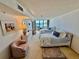 Bright bedroom with two beds, water view, and dresser at 2675 Gulf Of Mexico Dr # 203, Longboat Key, FL 34228