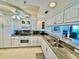 Bright kitchen featuring white cabinets and granite countertops at 2675 Gulf Of Mexico Dr # 203, Longboat Key, FL 34228