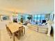 Open-concept living room featuring tile floors, dining area, and beach views at 2675 Gulf Of Mexico Dr # 203, Longboat Key, FL 34228