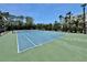 Well-maintained community tennis court surrounded by lush landscaping offers a recreational amenity at 2675 Gulf Of Mexico Dr # 203, Longboat Key, FL 34228