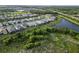 Community aerial view featuring homes and nearby lake and landscape at 2794 Butterfly Jasmine Trl, Sarasota, FL 34240