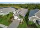 An aerial view of a one story home with mature landscaping and paver driveway at 2794 Butterfly Jasmine Trl, Sarasota, FL 34240