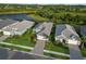 Aerial view of home, lush landscaping, paver driveway and beautiful surroundings at 2794 Butterfly Jasmine Trl, Sarasota, FL 34240