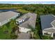 An aerial view of a one story home with mature landscaping and paver driveway at 2794 Butterfly Jasmine Trl, Sarasota, FL 34240