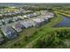 Community aerial view featuring homes and nearby lake and landscape at 2794 Butterfly Jasmine Trl, Sarasota, FL 34240
