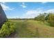 Lush backyard bordered by trees with scenic pond and well-maintained green space at 2794 Butterfly Jasmine Trl, Sarasota, FL 34240