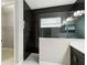 Sleek bathroom highlighting a walk-in shower with dark tiling, glass partition, and modern fixtures at 2794 Butterfly Jasmine Trl, Sarasota, FL 34240