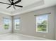 Spacious bedroom features tile floors, a ceiling fan, and multiple windows at 2794 Butterfly Jasmine Trl, Sarasota, FL 34240
