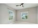 Bedroom featuring neutral walls, marble floors, and two large windows that let in plenty of natural light at 2794 Butterfly Jasmine Trl, Sarasota, FL 34240
