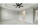 A bedroom features tile floors, ceiling fan, and ample natural light at 2794 Butterfly Jasmine Trl, Sarasota, FL 34240