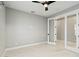 Spacious bedroom featuring marble floors, neutral walls, stylish ceiling fan and a view of the adjacent room at 2794 Butterfly Jasmine Trl, Sarasota, FL 34240