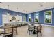 Stylish clubhouse lounge featuring a kitchen bar, tables, chairs, and an airy design at 2794 Butterfly Jasmine Trl, Sarasota, FL 34240