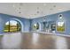 Spacious dance studio with large arched windows, mirrors, and hardwood floors at 2794 Butterfly Jasmine Trl, Sarasota, FL 34240