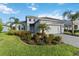 Charming one-story home with a well-manicured lawn, lush landscaping, and a brick paver driveway with great curb appeal at 2794 Butterfly Jasmine Trl, Sarasota, FL 34240