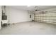 Spacious two car garage featuring an epoxy floor and utility sink at 2794 Butterfly Jasmine Trl, Sarasota, FL 34240