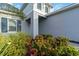 Close-up of a home entrance with vibrant landscaping and a well-manicured garden at 2794 Butterfly Jasmine Trl, Sarasota, FL 34240
