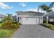 Charming home with a two-car garage, beautiful landscaping, and a brick driveway at 2794 Butterfly Jasmine Trl, Sarasota, FL 34240