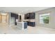 Modern kitchen with dark blue cabinets, white marble floors, and stainless-steel appliances, perfect for cooking at 2794 Butterfly Jasmine Trl, Sarasota, FL 34240