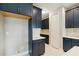 Close up kitchen shot with blue cabinets, marble backsplash, and stainless steel appliances at 2794 Butterfly Jasmine Trl, Sarasota, FL 34240