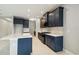 A modern kitchen featuring blue cabinets, marble backsplash, white countertops and stainless steel appliances at 2794 Butterfly Jasmine Trl, Sarasota, FL 34240