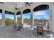 Covered outdoor seating area with views of the pool and landscaping at 2794 Butterfly Jasmine Trl, Sarasota, FL 34240