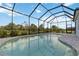Relaxing pool offers a scenic view, enhanced by the surrounding brick pavers at 2794 Butterfly Jasmine Trl, Sarasota, FL 34240