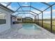 Backyard pool with a screened enclosure and brick pavers, providing a cozy outdoor space at 2794 Butterfly Jasmine Trl, Sarasota, FL 34240