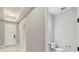 Bright powder room featuring neutral walls, white trim, and a toilet with modern fixtures next to the entryway at 2794 Butterfly Jasmine Trl, Sarasota, FL 34240