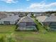 Aerial view of the backyard with a screened-in pool and well-maintained lawn at 2794 Butterfly Jasmine Trl, Sarasota, FL 34240