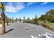 Picturesque recreation area featuring bench seating, lawn games, and a tranquil view of the community lake at 2794 Butterfly Jasmine Trl, Sarasota, FL 34240