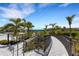 Charming walkway with tropical landscaping leading to the community pool area at 2794 Butterfly Jasmine Trl, Sarasota, FL 34240