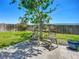 Backyard featuring a small tree, patio with rocking chairs, and a well-manicured lawn at 2801 21St W Ave, Bradenton, FL 34205