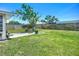 Spacious backyard with lush green grass, mature trees, and a charming patio area for outdoor enjoyment at 2801 21St W Ave, Bradenton, FL 34205