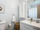 Bright bathroom featuring a white vanity, medicine cabinet, toilet and a seashell art piece at 2801 21St W Ave, Bradenton, FL 34205