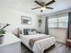 Serene bedroom with a ceiling fan, neutral colors, and natural light from window at 2801 21St W Ave, Bradenton, FL 34205