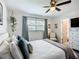 Relaxing bedroom features a ceiling fan, a dresser, and a view into the bathroom at 2801 21St W Ave, Bradenton, FL 34205