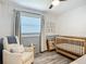 Neutral Bedroom featuring a crib, glider chair, window, and stylish decor at 2801 21St W Ave, Bradenton, FL 34205