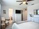 Cozy bedroom features a ceiling fan, a white dresser, and a comfortable chair at 2801 21St W Ave, Bradenton, FL 34205