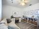 Bright bedroom featuring sofa, workspace, shelving, and decorative animal artwork at 2801 21St W Ave, Bradenton, FL 34205
